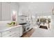 Bright kitchen features marble countertops, stainless steel appliances, and large windows overlooking the backyard at 909 Lake Boone Trl, Raleigh, NC 27607