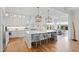 Bright, white kitchen featuring a large island with seating, pendant lighting, and modern appliances at 909 Lake Boone Trl, Raleigh, NC 27607