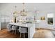 Bright kitchen features a large island with marble countertops, breakfast bar seating, and gold pendant lighting at 909 Lake Boone Trl, Raleigh, NC 27607