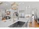 Open concept kitchen features a large island with marble countertops, stainless appliances, and recessed lighting at 909 Lake Boone Trl, Raleigh, NC 27607
