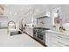 Gourmet kitchen with marble countertops, stainless steel appliances, and a decorative tile backsplash at 909 Lake Boone Trl, Raleigh, NC 27607