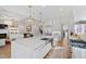 Open concept kitchen features stainless steel appliances, a large island, and a view of the living area at 909 Lake Boone Trl, Raleigh, NC 27607