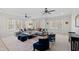 Spacious living room with large sectional sofa, stylish decor, ceiling fans, and natural light, perfect for relaxation at 909 Lake Boone Trl, Raleigh, NC 27607