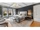 Serene main bedroom featuring an elegant bed, stylish decor, and ample natural light for a relaxing retreat at 909 Lake Boone Trl, Raleigh, NC 27607