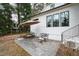Charming outdoor patio with an umbrella, seating, and a view of the house perfect for relaxation and entertainment at 909 Lake Boone Trl, Raleigh, NC 27607