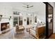 Cozy sunroom with brick fireplace, ceiling fan, and neutral toned furniture at 909 Lake Boone Trl, Raleigh, NC 27607