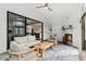 Cozy sunroom with comfortable seating, a fireplace, and seamless indoor-outdoor flow to the kitchen at 909 Lake Boone Trl, Raleigh, NC 27607