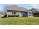View of the backyard with the back of the house, porch, and luscious green grass at 9117 Cornwell Dr, Wake Forest, NC 27587