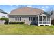 Green backyard featuring a screened-in porch, well-kept lawn and neutral siding at 9117 Cornwell Dr, Wake Forest, NC 27587