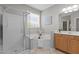 Well-lit bathroom featuring a glass-enclosed shower, a soaking tub, and a vanity at 9117 Cornwell Dr, Wake Forest, NC 27587