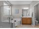 Well-lit bathroom featuring a glass-enclosed shower, a soaking tub, and a vanity at 9117 Cornwell Dr, Wake Forest, NC 27587