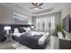 Comfortable main bedroom with decorative tray ceiling, ceiling fan, and large windows at 9117 Cornwell Dr, Wake Forest, NC 27587