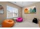 Cozy bedroom with colorful beanbag chairs, playful artwork, and a ceiling fan at 9117 Cornwell Dr, Wake Forest, NC 27587