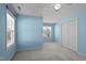 Bright bedroom with pale blue walls, two windows, a ceiling fan, and a closet at 9117 Cornwell Dr, Wake Forest, NC 27587