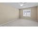 Bright, empty bedroom with neutral walls, light carpeting, and a single window with blinds at 9117 Cornwell Dr, Wake Forest, NC 27587