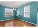 Bright dining room with hardwood floors, modern chandelier, and large windows offering abundant natural light at 9117 Cornwell Dr, Wake Forest, NC 27587