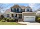 Beautiful home with stone accents, a covered porch, and an attached two-car garage at 9117 Cornwell Dr, Wake Forest, NC 27587