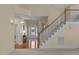 Open and inviting foyer with hardwood flooring and staircase leading to upper level at 9117 Cornwell Dr, Wake Forest, NC 27587