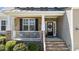 Cozy front porch with stone accents, comfortable seating, and a welcoming entrance at 9117 Cornwell Dr, Wake Forest, NC 27587