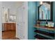 Charming hallway featuring a custom-built bar with granite countertop, elegant mirror, and decorative lighting at 9117 Cornwell Dr, Wake Forest, NC 27587