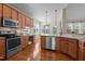 Spacious kitchen features stainless steel appliances, granite countertops, and beautiful hardwood flooring at 9117 Cornwell Dr, Wake Forest, NC 27587