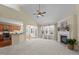 Bright open living room with fireplace, ceiling fan, and view into the kitchen and sunroom at 9117 Cornwell Dr, Wake Forest, NC 27587
