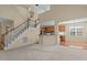 Open floor plan view of staircase and kitchen with breakfast bar and a view to the sunroom at 9117 Cornwell Dr, Wake Forest, NC 27587