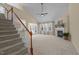 Bright living room with a fireplace, neutral walls, and a staircase leading to the second floor at 9117 Cornwell Dr, Wake Forest, NC 27587