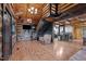 Inviting living area featuring wood walls, an open staircase, wood floors, and a stylish chandelier at 9409 Wheelers Church Rd, Hurdle Mills, NC 27541