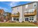 Back exterior view of townhomes, featuring small balconies and well-manicured lawn at 10008 Secluded Garden Drive Rd # 182, Apex, NC 27523