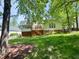 The backyard has a spacious deck, a screened-in porch, and lush green grass at 102 Caymus Ct, Cary, NC 27519