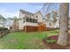 Backyard featuring a two-story house with a wood deck and patio at 102 Caymus Ct, Cary, NC 27519