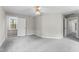 Spacious bedroom features neutral paint, gray carpet, and a ceiling fan, with a door leading to the hallway at 102 Caymus Ct, Cary, NC 27519