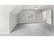 Bedroom features gray carpet, light-colored walls, and a window for natural light at 102 Caymus Ct, Cary, NC 27519
