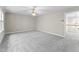Spacious bonus room with neutral carpet, ceiling fan, and access to the upstairs hallway at 102 Caymus Ct, Cary, NC 27519