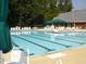 Large community pool with multiple lanes for swimming, with chairs and tables, perfect for relaxation and recreation at 102 Caymus Ct, Cary, NC 27519