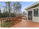 A wooden deck with brown railings overlooks the backyard and access to a screened-in porch at 102 Caymus Ct, Cary, NC 27519