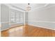 Dining room features hardwood floors, neutral walls, decorative chandelier, and large window at 102 Caymus Ct, Cary, NC 27519