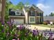 Charming brick home with lush green lawn and two-car garage at 102 Caymus Ct, Cary, NC 27519