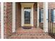 Elegant front door with decorative columns and brick steps at 102 Caymus Ct, Cary, NC 27519