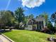 Beautiful brick two-story home with well-maintained lawn, lush shrubbery and shade trees, creating a welcoming curb appeal at 102 Caymus Ct, Cary, NC 27519