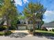 Charming two-story brick home with attached garage and well-manicured front yard landscaping and shade trees at 102 Caymus Ct, Cary, NC 27519