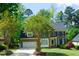Inviting brick-front home with a well-manicured lawn, mature trees, and a two-car garage at 102 Caymus Ct, Cary, NC 27519