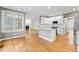 Modern kitchen with granite countertops, white cabinets, and stainless steel appliances at 102 Caymus Ct, Cary, NC 27519