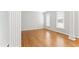 Open-concept living room with hardwood floors and neutral paint at 102 Caymus Ct, Cary, NC 27519