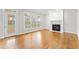 Bright living room featuring a fireplace and hardwood floors at 102 Caymus Ct, Cary, NC 27519