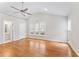 Bright main bedroom features hardwood floors, ceiling fan, large windows and ensuite bathroom at 102 Caymus Ct, Cary, NC 27519