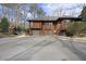 Spacious three-car garage with ample parking in the driveway and a glimpse of a playset in the yard at 10509 Leslie Dr, Raleigh, NC 27615