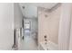Well-lit bathroom featuring a shower-tub combo with tile surround and neutral walls at 109 Aisling Ct, Cary, NC 27513