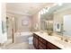 Bathroom featuring a glass shower, soaking tub, and double sink vanity with wood cabinets at 109 Aisling Ct, Cary, NC 27513